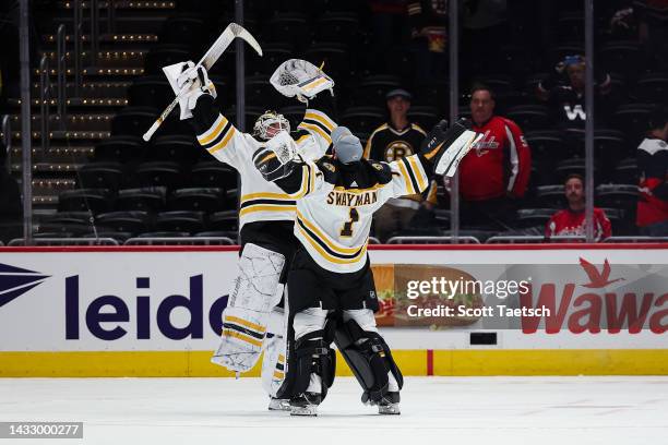 Goaltenders Linus Ullmark and Jeremy Swayman of the Boston Bruins celebrate after the game against the Washington Capitals at Capital One Arena on...