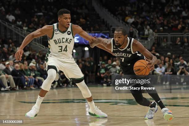 Kevin Durant of the Brooklyn Nets is defended by Giannis Antetokounmpo of the Milwaukee Bucks during the second half of a preseason game at Fiserv...