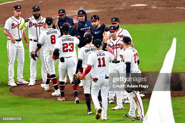 The Atlanta Braves celebrate after defeating the Philadelphia Phillies in game two of the National League Division Series at Truist Park on October...