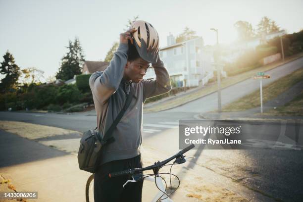 cyclist riding bike in city setting - fall in seattle stock pictures, royalty-free photos & images