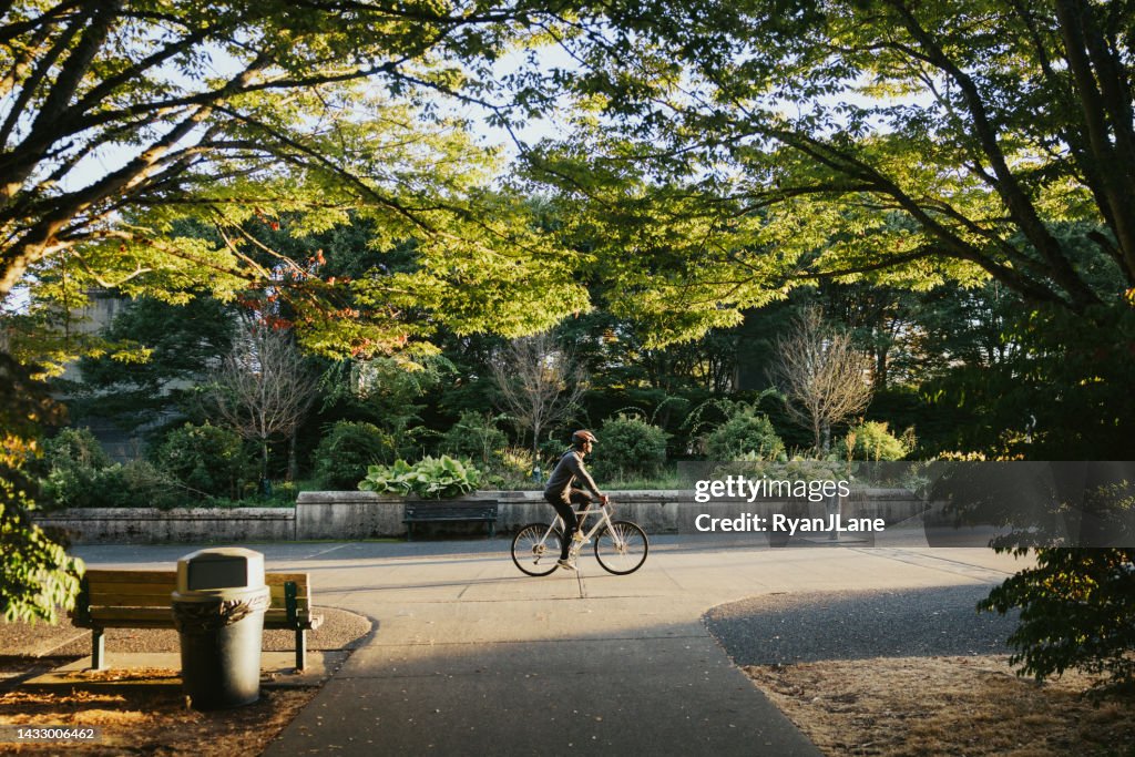 Cyclist Riding Bike in City Setting