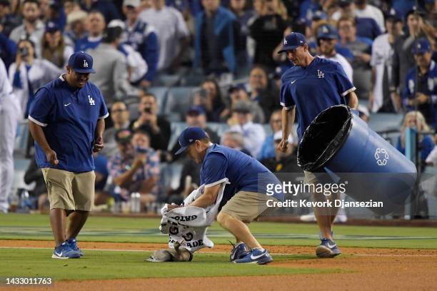 Los Angeles Dodgers grounds crew members attempt to escort a goose off the field in the eighth inning in game two of the National League Division...