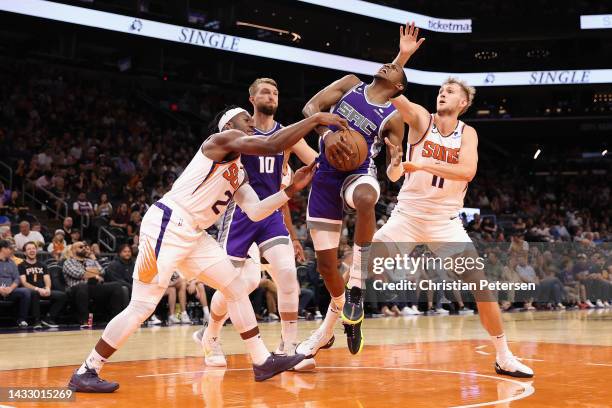 De'Aaron Fox of the Sacramento Kings drives against Josh Okogie of the Phoenix Suns during the first half of the preseason NBA game at Footprint...