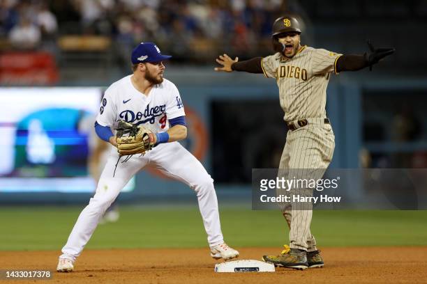 Trent Grisham of the San Diego Padres reacts after sliding safely into second base against Gavin Lux of the Los Angeles Dodgers in the eighth inning...