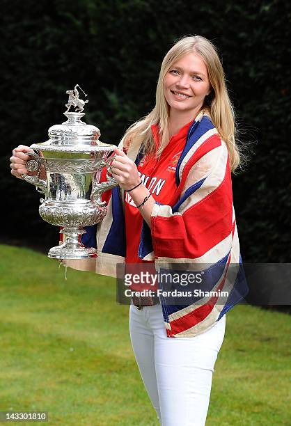 Jodie Kidd holds the Olympic Polo Trophy and wears the official Union flag which was flown at the 1936 Summer Olympics in Berlin as she attends the...