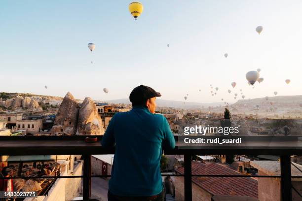 asian adult using laptop during traveling in cappadocia - göreme stock pictures, royalty-free photos & images