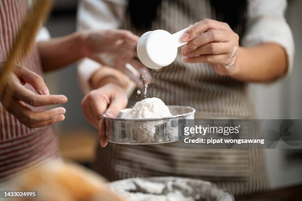 asian girlfriend helping to make homemade bakery in the kitchen. - pizza toss foto e immagini stock
