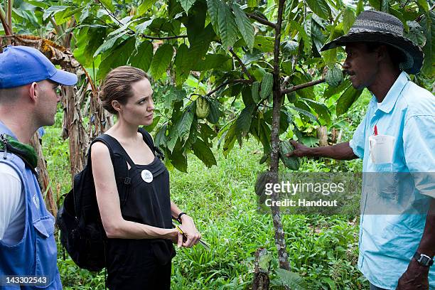 In this handout image provided by UNHCR, UNHCR Special Envoy Angelina Jolie meets with Plinio in the Providencia community on April 22, 2012 in...