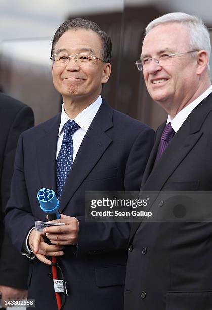 Chinese Premier Wen Jiabao holds the plus for a Volkswagen electric car while standing next to Volkswagen CEO Martin Winterkorn at the Volkswagen...