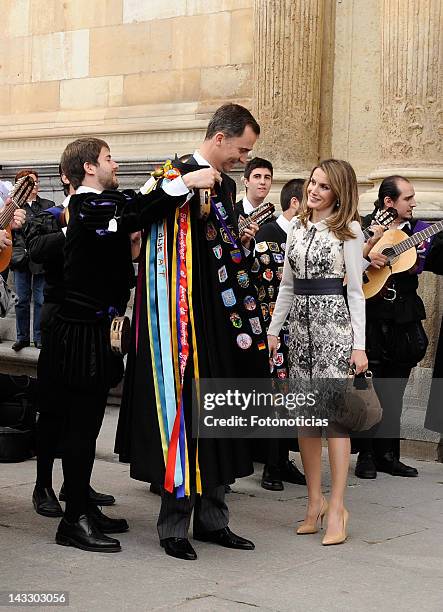 Prince Felipe of Spain and Princess Letizia of Spain speak with members of a tarditional 'Tuna' musical group members after the Cervantes Awards...