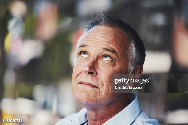 middle aged man rolling his eyes - rollen met de ogen stockfoto's en -beelden