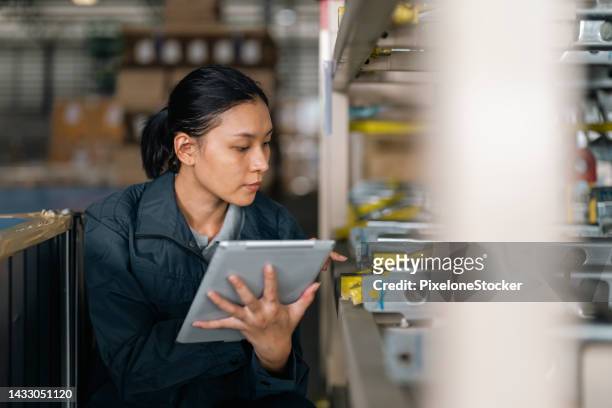 female worker working at factory warehouse checking the product before packaging and transportation. - demanding boss stock pictures, royalty-free photos & images