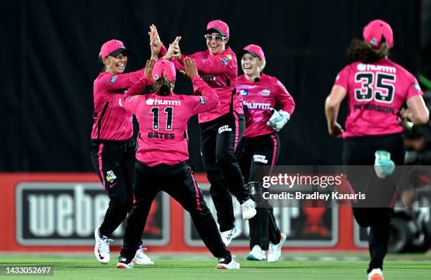 Nicole Bolton of the Sixers celebrates with team mates after taking the catch to dismiss Grace Harris of the Heat during the Women's Big Bash League...