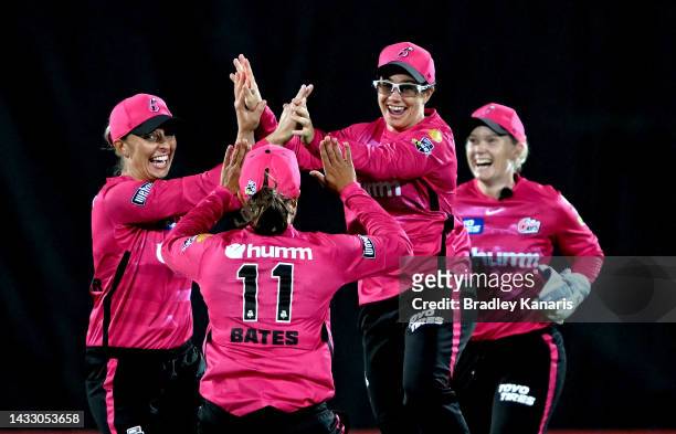 Nicole Bolton of the Sixers celebrates with team mates after taking the catch to dismiss Grace Harris of the Heat during the Women's Big Bash League...
