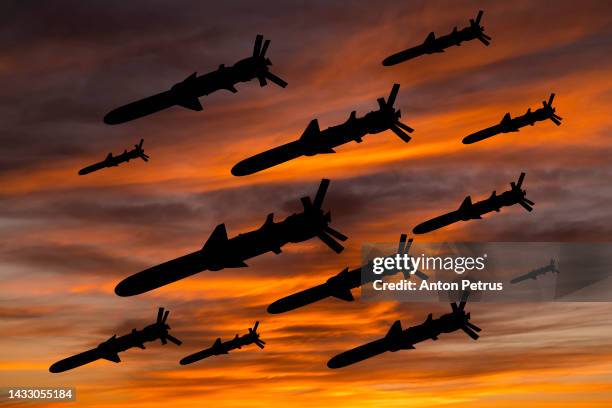 cruise missiles against the sunset sky - luchtaanval stockfoto's en -beelden