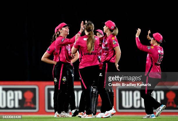 Angie Genford of the Sixers celebrates taking the catch to dismiss Georgia Redmayne of the Heat during the Women's Big Bash League match between the...