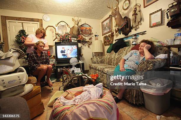 Drucilla Smith has her hair done as she prepares for the Owsley County High School prom in her home with sister Linda Hall , Layla Johnson and mother...