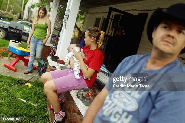 Family members Ronnie Duff, Love Faith Duff, Jacob Lucas and Hope Lucas gather on the porch in Owsley County on April 20, 2012 in Booneville,...