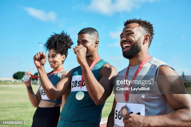 podium, sports winner and happy people together celebrate winning race success, victory and medal. motivation, celebration and happiness of champion young athlete team smile celebrating achievement - sportsperson medal stock pictures, royalty-free photos & images