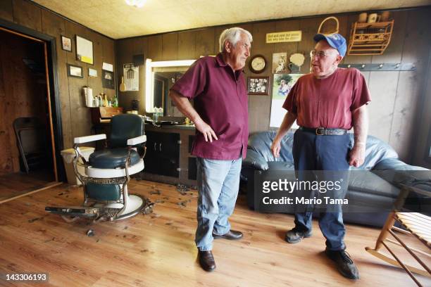 Barber Gary Mays chats with retired butcher Jesse Johnson in Mays' barber shop in Owsley County on April 20, 2012 in Booneville, Kentucky. Daniel...