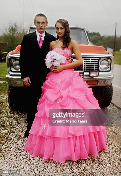 Dates Coty Shouse and Destiny Duff pose in front of the vehicle they will take to prom while preparing for the Owsley County High School prom on...
