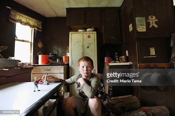 Mose Noble's nephew Johnny Noble sits in Mose's trailer during a visit on April 21, 2012 in Owsley County, Kentucky. Johnny visits his uncle from...