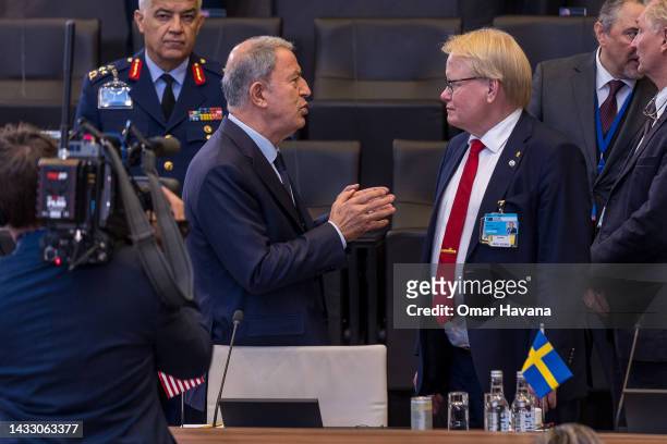 Turkish Defence Minister Hulusi Akar speaks with Swedish Defence Minister Peter Hultqvist upon their arrival at the North Atlantic Council meeting of...