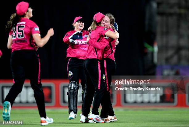 Angie Genford of the Sixers is congratulated by team mates after taking the wicket of Georgia Voll of the Heat during the Women's Big Bash League...