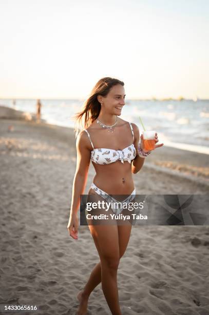 young female girl wearing bikini enjoying time on summer vacation. - tanned body stock pictures, royalty-free photos & images
