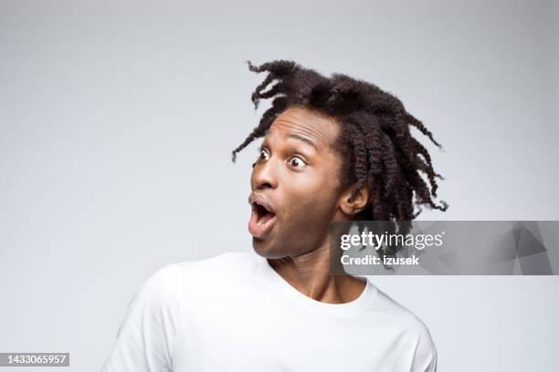 potrait of excited man in white t-shirt - man look side stock pictures, royalty-free photos & images