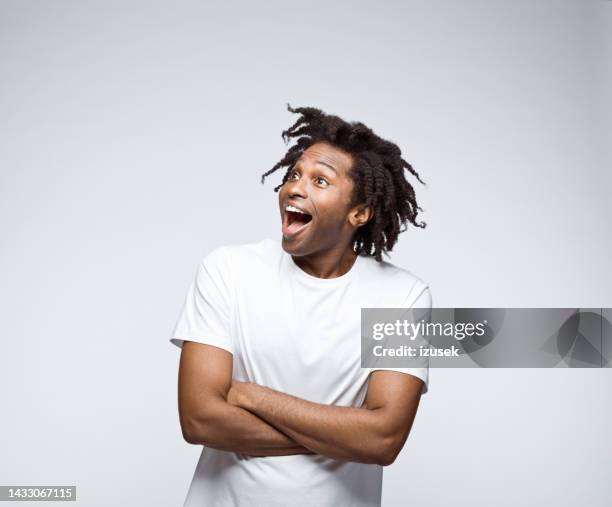 potrait of surprised man in white t-shirt - black t shirt stock pictures, royalty-free photos & images