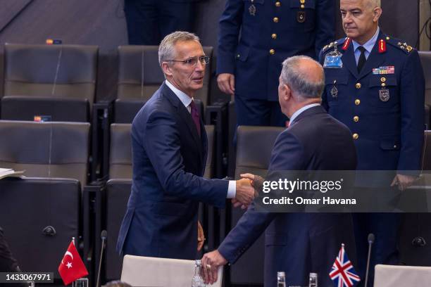 Secretary General Jens Stoltenberg greets Turkish Defence Minister Hulusi Akar at the start of the North Atlantic Council Defence Ministers' meeting...