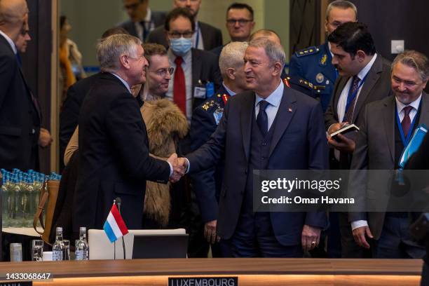 Turkish Defence Minister Hulusi Akar greets his Luxembourgian counterpart François Bausch at the start of the North Atlantic Council defence...