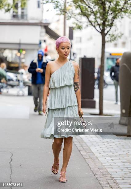 Guest wears asymmetric dress outside Lanvin during Paris Fashion Week - Womenswear Spring/Summer 2023 : Day Eight on October 03, 2022 in Paris,...