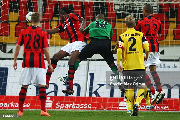 Mohamadou Idrissou of Frankfurt scores his team's first goal against goalkeeper Boy Waterman of Aachen during the Second Bundesliga match between...