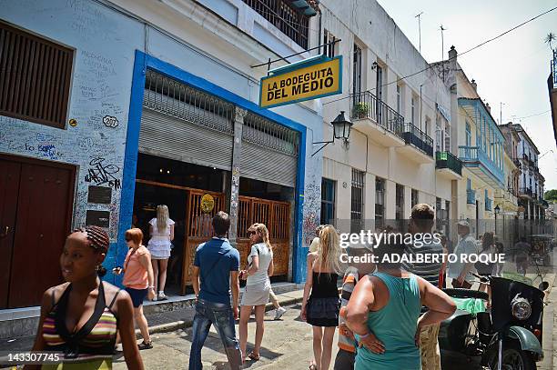 By Francisco Jara Tourists visit the famous Bodeguita del Medio bar in the Cuban capital, Havana, on April 23, 2012. April 26 will mark the 70th...