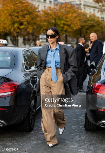 Alexandra Guerain wears grey oversized blazer, beige pants, blue button shirt outside Rokh during Paris Fashion Week - Womenswear Spring/Summer 2023...