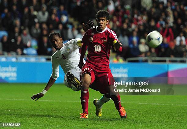 Abdoulaye Sane of Senagal battles with Hussain Al Hadhri of Oman during the London 2012 Olympic Qualifier between Senegal and Oman at Ricoh Arena on...