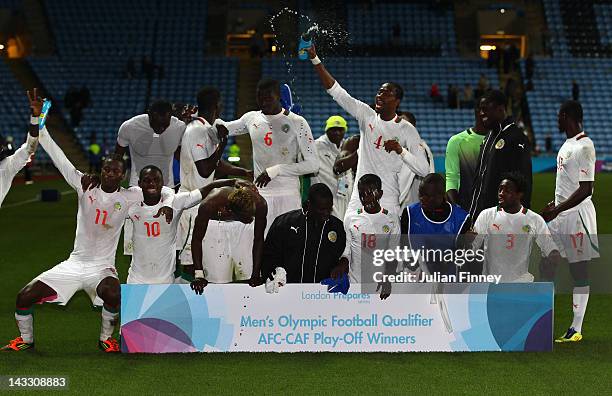 The Senegal team celebrate their qualification to the Olympics during the London 2012 Olympic Qualifier match between Senegal and Oman at the Ricoh...