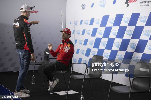 Aleix Espargaro of Spain and Aprilia Racing speaks with Francesco Bagnaia of Italy and Ducati Lenovo Team during the press conference pre-event...