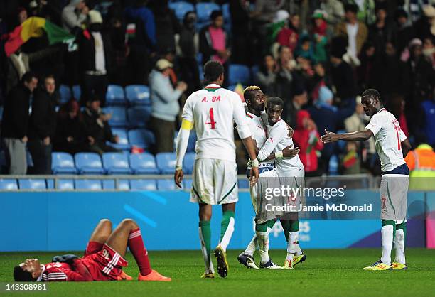 Players of Senagal celebrate progressing to the Olympic games during the London 2012 Olympic Qualifier between Senegal and Oman at Ricoh Arena on...