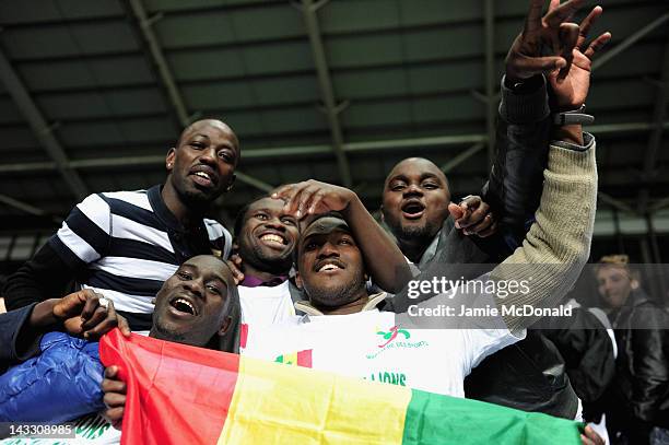 Fans of Senagal celebrate progressing to the Olympic games during the London 2012 Olympic Qualifier between Senegal and Oman at Ricoh Arena on April...