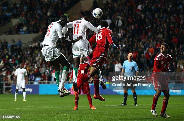 Ibrahima Balde heads for goal during the London 2012 Olympic Qualifier match between Senegal and Oman at the Ricoh Arena on April 23, 2012 in...