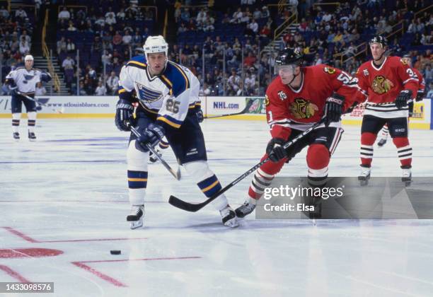 Pascal Rheaume from Canada and Left Wing for the St Louis Blues and Dmitri Tolkunov of the Chicago Blackhawks challenge for the puck during their NHL...