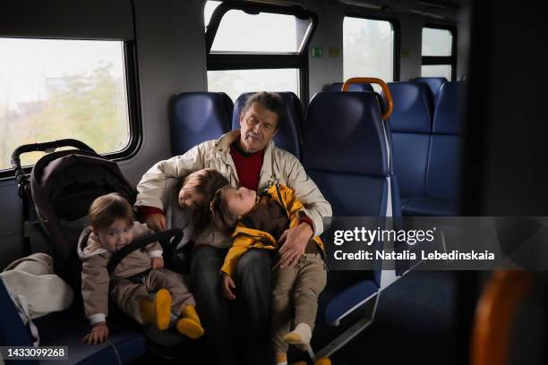 elderly man sleep rest in electric train with his grandchildren's. local travel with kids. - senior public transportation stock pictures, royalty-free photos & images