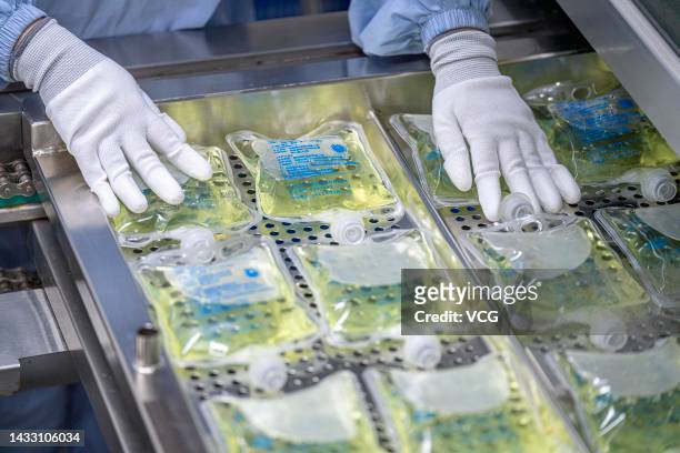 An employee works on the production line of Moxifloxacin hydrochloride and sodium chloride injection at a workshop of Hainan Aike Pharmaceutical Co.,...