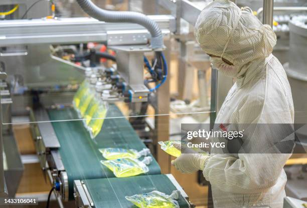 An employee works on the production line of Moxifloxacin hydrochloride and sodium chloride injection at a workshop of Hainan Aike Pharmaceutical Co.,...