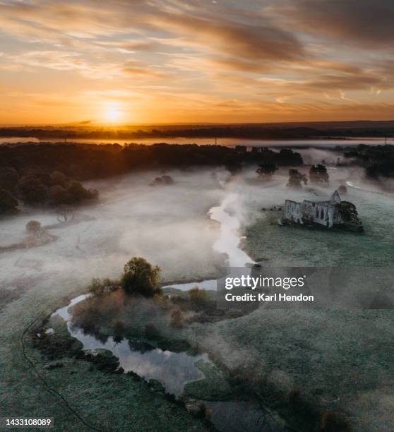 an aerial sunrise view newark abbey ruins, surrey - england river landscape stock pictures, royalty-free photos & images