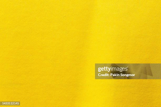 yellow color sports clothing fabric football shirt jersey texture and textile background. - jersey soccer foto e immagini stock