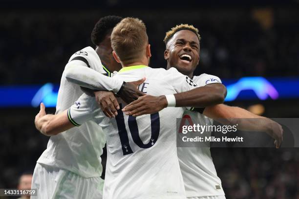 Harry Kane of Tottenham Hotspur celebrates with team mates Emerson and Ryan Sessegnon after scoring from the penalty spot during the UEFA Champions...